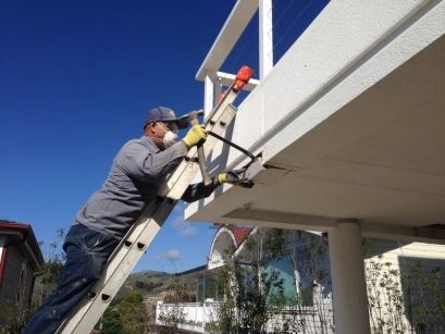 DeckTech team member repairing a roof deck